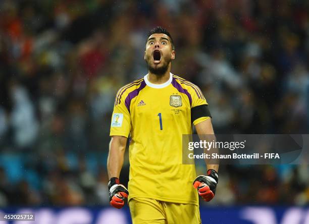 Sergio Romero of Argentina reacts after stopping the penalty kick by Wesley Sneijder of the Netherlands in the penalty shootout during the 2014 FIFA...