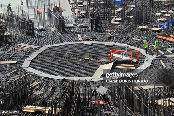 People work on a nuclear reactor at the construction site of the International Thermonuclear Experimental Reactor on July11, 2014 in...