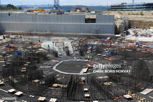 People work on a nuclear reactor at the construction site of the International Thermonuclear Experimental Reactor on July11, 2014 in...