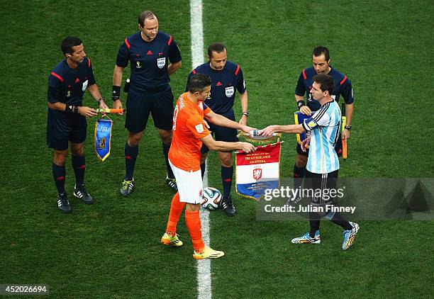 Robin van Persie of the Netherlands exchanges match pennants with Lionel Messi of Argentina prior to the 2014 FIFA World Cup Brazil Semi Final match...