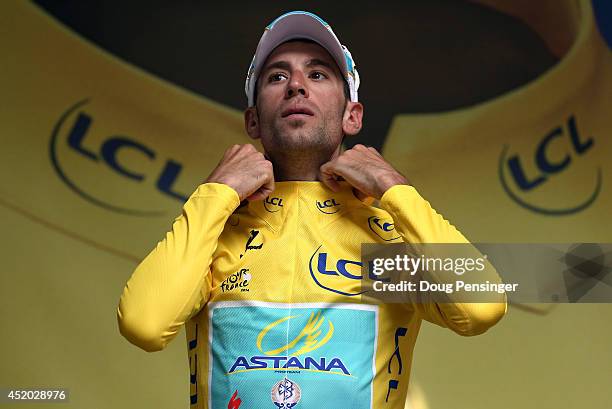 Vincenzo Nibali of Italy and the Astana Pro Team takes the podium after defending the overall race leader's yellow jersey in stage seven of the 2014...