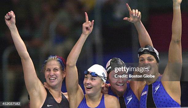 The USA women's swim team celebrates a world record performance in the women's 4x100-meter medley relay. Left to right: BJ Bedford, Megan Quann,...