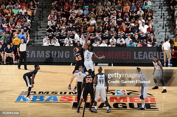 Cole Aldrich of the New York Knicks and Bernard James of the Dallas Mavericks jump ball at the Samsung NBA Summer League 2014 on July 11, 2014 at the...