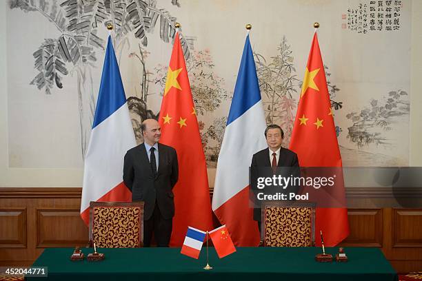 France's Finance Minister Pierre Moscovici and China's Vice Premier Ma Kai attend a joint press conference following a signing ceremony at a...