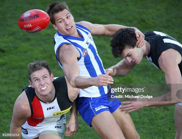 Andrew Swallow of the Kangaroos competes for the ball against David Armitage of the Saints and Dylan Roberton of the Saints during the round 17 AFL...