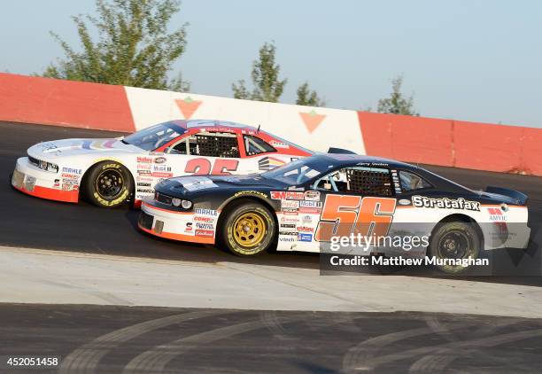 Joey McColm, driver of the Canada's Best Store Fixtures Dodge and Larry Jackson, driver of the AVMIC/B&B Decals Dodge battle for position during the...