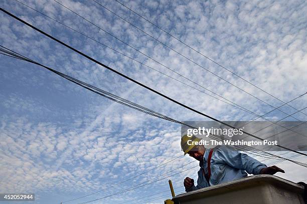 Pepco employee, James Tarantella climbs out of a bucket after fixing a blown fuse on a power outage call on Monday August 13, 2012 in Rockville, MD....