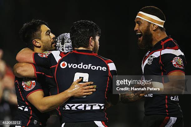 Shaun Johnson of the Warriors celebrates with Chad Townsend and Manu Vatuvei after scoring a try during the round 18 NRL match between the New...