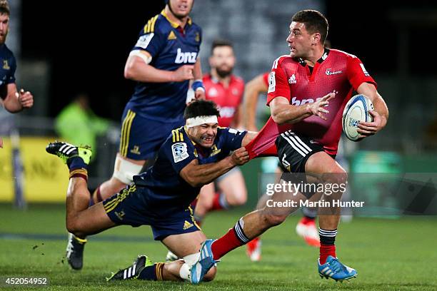 Kieron Fonotia of the Crusaders breaks away from the tackle of Shane Christie of the Highlanders during the round 19 Super Rugby match between the...