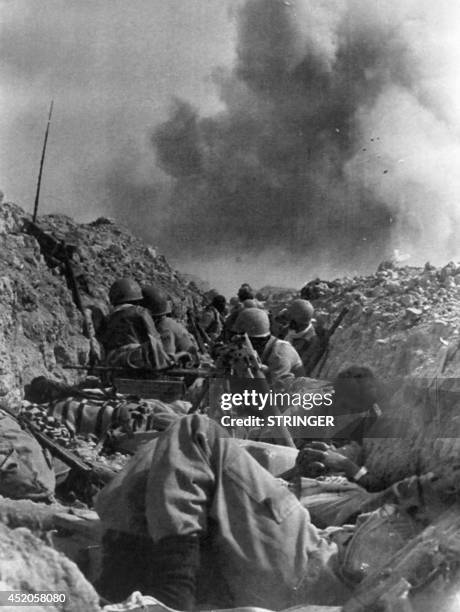 Picture released on July 17, 1982 of Iranian soldiers fighting in the trenches battlefield of Ahvaz, during the Ramadan offensive of the IranIraq...