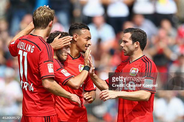 Hakan Calhanoglu celebrates his first goal with Stefan Kiessling , Karim Bellarabi and Gonzalo Castro of Leverkusen during the friendly match between...