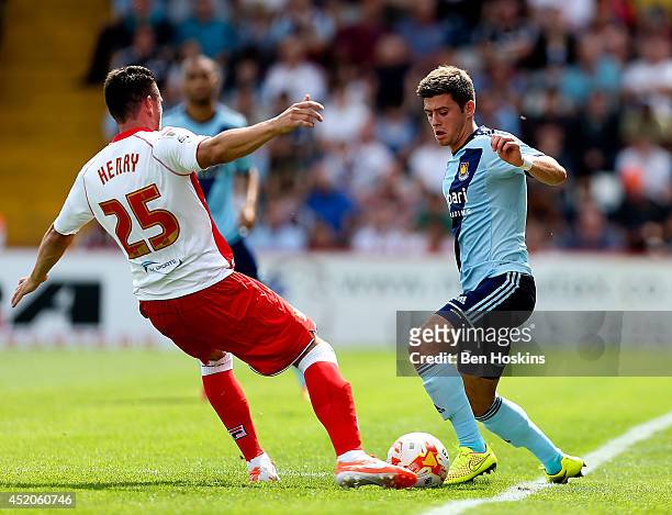 Aaron Cresswell of West Ham is put under pressure by Ronnie Henry of Stevenage during the Pre Season Friendly match between Stevenage and West Ham...
