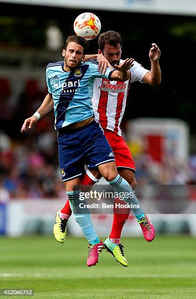 Diego Poyet of West Ham and Simon Walton of Stevenage challenge for an aerial ball during the Pre Season Friendly match between Stevenage and West...