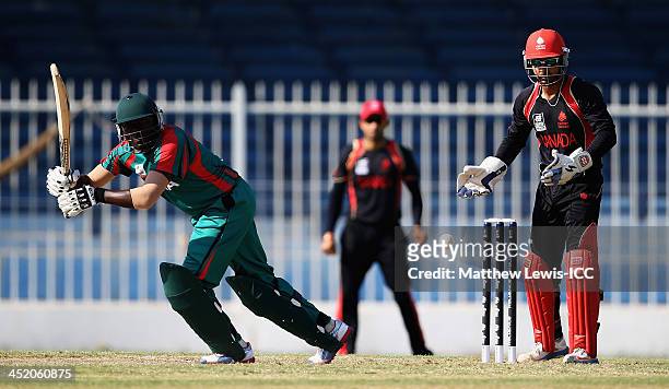 Steve Tikolo of Kenya hits the ball towards the boundary, as Ashish Bagai of Canada looks on during the ICC World Twenty20 Qualifier 11th Place...