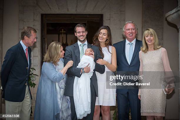 Grand Duke Henri and Grand Duchess Maria-Teresa of Luxembourg, pose with their son Prince Felix holding his daughter Princess Amalia, and his wife...