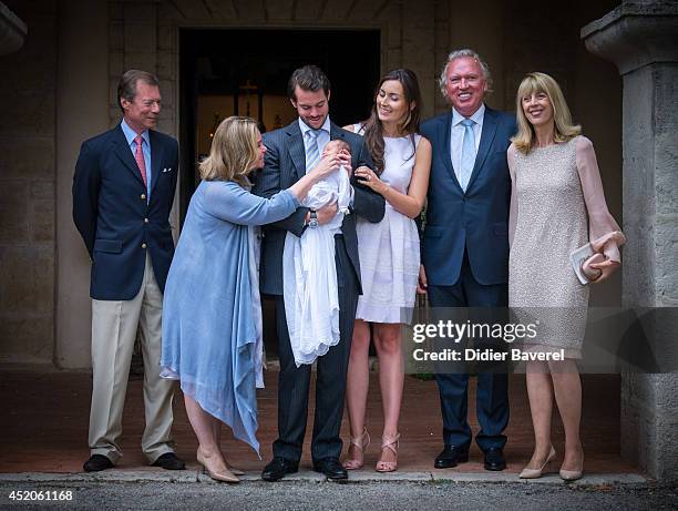 Grand Duke Henri and Grand Duchess Maria-Teresa of Luxembourg, pose with their son Prince Felix holding his daughter Princess Amalia, and his wife...