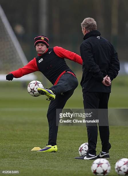 Wayne Rooney of Manchester United is closely watched by his manager David Moyes during a first team training session ahead of their UEFA Champions...