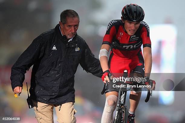 Tejay van Garderen of the USA and the BMC Racing Team is given a helping hand after crossing the finish line on stage eight of the 2014 Tour de...