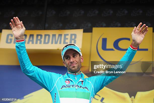 Vincenzo Nibali of Italy and the Astana Pro Team takes the podium after defending the overall race leader's yellow jersey on the eighth stage of the...