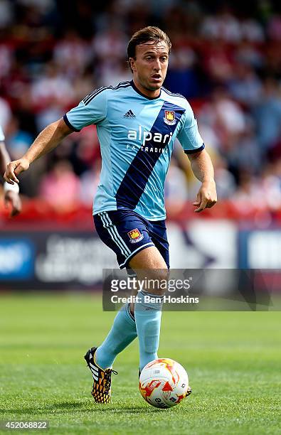 Mark Noble of West Ham in action during the Pre Season Friendly match between Stevenage and West Ham United at The Lamex Stadium on July 12, 2014 in...