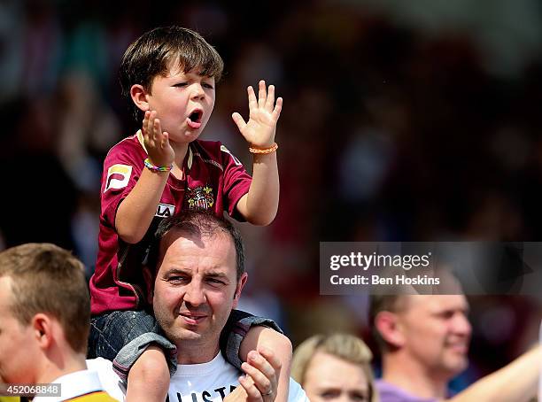 Young Stevenage fan cheers on his side during the Pre Season Friendly match between Stevenage and West Ham United at The Lamex Stadium on July 12,...