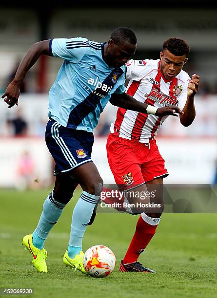 Mo Diame of West Ham advances under pressure from Rohdell Gordon of Stevenage during the Pre Season Friendly match between Stevenage and West Ham...