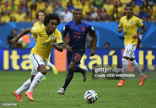 Brazil's midfielder Willian and Netherlands' midfielder Georginio Wijnaldum vie during the third place play-off football match between Brazil and...