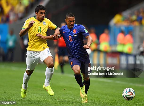Jonathan de Guzman of the Netherlands holds off a challenge by Paulinho of Brazil during the 2014 FIFA World Cup Brazil Third Place Playoff match...