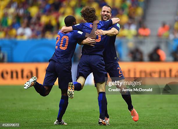 Daley Blind of the Netherlands celebrates scoring his team's second goal with Georginio Wijnaldum and Ron Vlaar during the 2014 FIFA World Cup Brazil...