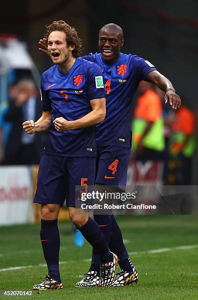 Daley Blind of the Netherlands celebrates scoring his team's second goal with teammate Bruno Martins Indi during the 2014 FIFA World Cup Brazil Third...