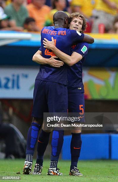 Daley Blind of the Netherlands celebrates scoring his team's second goal with teammate Bruno Martins Indi during the 2014 FIFA World Cup Brazil Third...