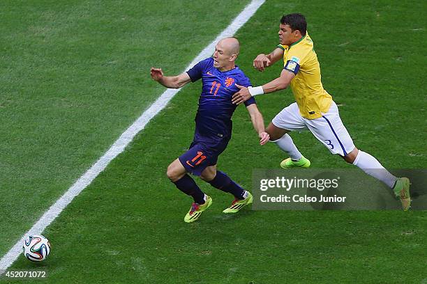 Thiago Silva of Brazil challenges Arjen Robben of the Netherlands resulting in a penalty kick for the Netherlands and yellow card for Silva during...