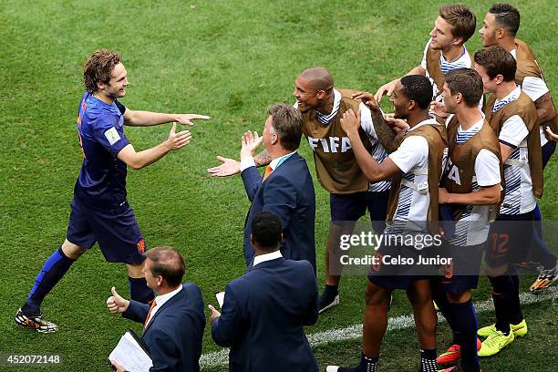 Daley Blind of the Netherlands celebrates scoring his team's second goal with teammates and head coach Louis van Gaal during the 2014 FIFA World Cup...