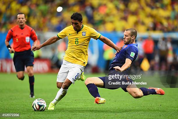 Ron Vlaar of the Netherlands challenges Paulinho of Brazil during the 2014 FIFA World Cup Brazil Third Place Playoff match between Brazil and the...