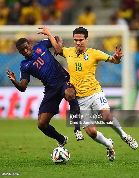 Georginio Wijnaldum of the Netherlands and Hernanes of Brazil compete for the ball during the 2014 FIFA World Cup Brazil Third Place Playoff match...
