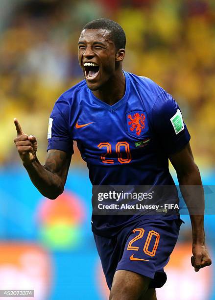 Georginio Wijnaldum of the Netherlands celebrates scoring his team's third goal during the 2014 FIFA World Cup Brazil 3rd Place Playoff match between...