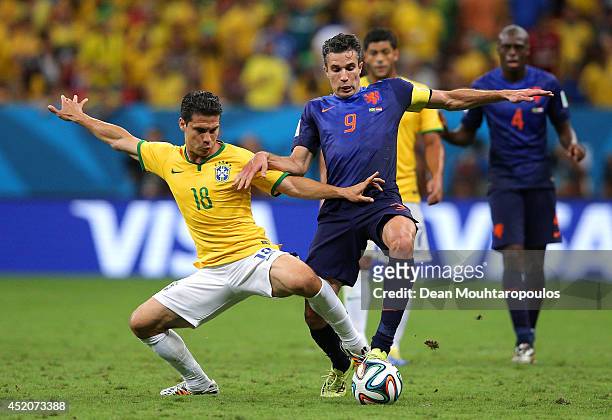 Hernanes of Brazil challenges Robin van Persie of the Netherlands during the 2014 FIFA World Cup Brazil Third Place Playoff match between Brazil and...