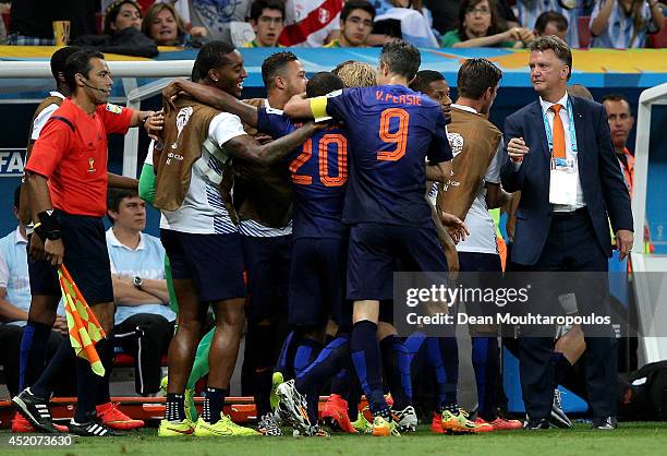 Georginio Wijnaldum of the Netherlands celebrates scoring his team's third goal with teammates during the 2014 FIFA World Cup Brazil Third Place...
