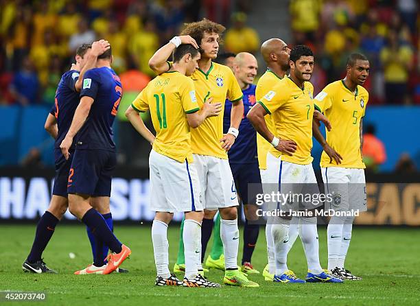 David Luiz consoles Oscar of Brazil as Hulk and Fernandinho of Brazil look on after a 3-0 defeat to the Netherlands during the 2014 FIFA World Cup...