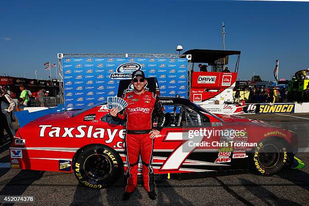 Regan Smith, driver of the TaxSlayer.com Chevrolet, celebrates winning the Nationwide Dash4Cash during the NASCAR Nationwide Series Sta-Green 200 at...