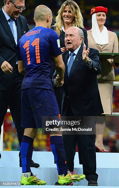 Arjen Robben of the Netherlands is presented with his medal by FIFA President Joseph S. Blatter after defeating Brazil 3-0 during the 2014 FIFA World...