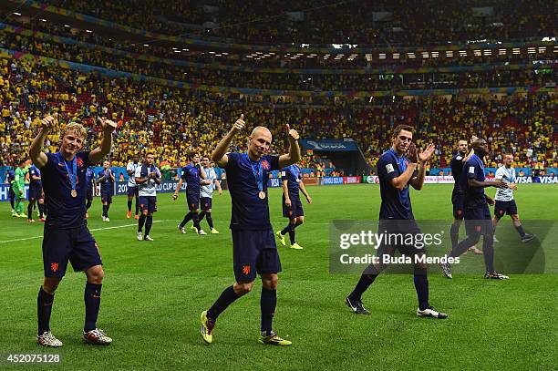 Dirk Kuyt, Arjen Robben, Stefan de Vrij and Bruno Martins Indi of the Netherlands acknowledge the fans after defeating Brazil 3-0 in the 2014 FIFA...