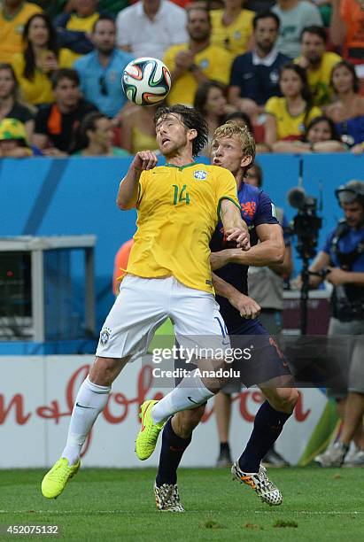 Dirk Kuyt of the Netherlands vies for the ball with Maxwell of Brazil during the 2014 FIFA World Cup Brazil Third Place Playoff match between Brazil...