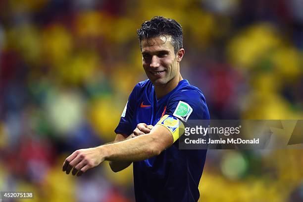Robin van Persie of the Netherlands takes off his captain armband after defeating Brazil 3-0 in the 2014 FIFA World Cup Brazil Third Place Playoff...