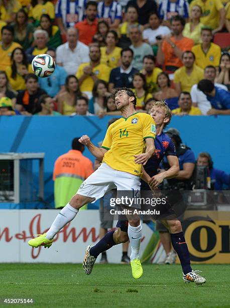 Dirk Kuyt of the Netherlands vies for the ball with Maxwell of Brazil during the 2014 FIFA World Cup Brazil Third Place Playoff match between Brazil...