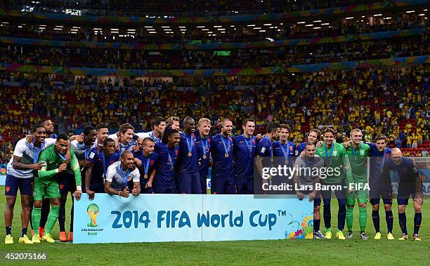 Netherlands players pose for photographs during the medal ceremony after the 2014 FIFA World Cup Brazil 3rd Place Playoff match between Brazil and...