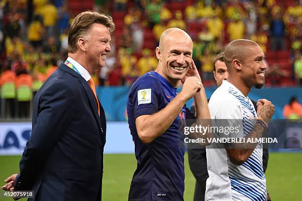 Netherlands' coach Louis van Gaal, Netherlands' forward Arjen Robben and Netherlands' midfielder Nigel de Jong celebrate at the end of the third...