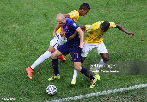 Arjen Robben of the Netherlands is challenged by Luiz Gustavo and Ramires of Brazil during the 2014 FIFA World Cup Brazil Third Place Playoff match...