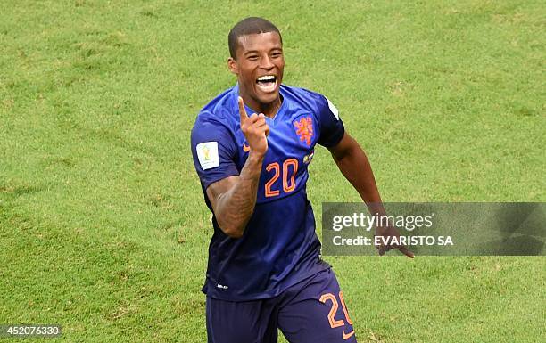 Netherlands' midfielder Georginio Wijnaldum celebrates after scoring a goal during the third place play-off football match between Brazil and...