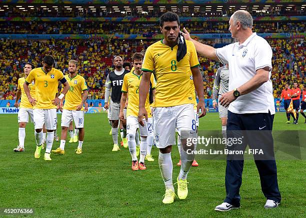 Paulinho of Brazil is consoled by head coach Luiz Felipe Scolari of Brazil after the 2014 FIFA World Cup Brazil 3rd Place Playoff match between...